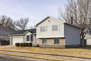 View of front facade featuring a garage