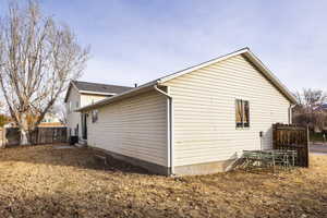 View of side of property featuring central air condition unit