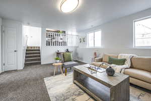 Carpeted living room featuring a textured ceiling