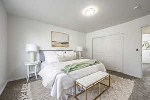 Carpeted bedroom featuring a closet