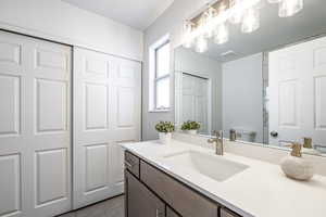 Bathroom featuring tile patterned flooring, vanity, and toilet