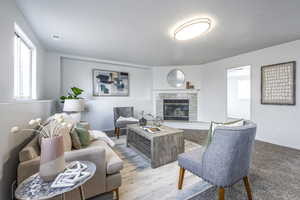 Carpeted living room featuring a fireplace