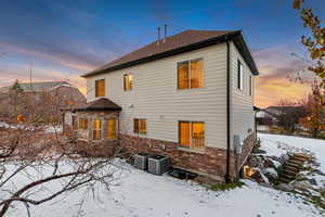 Snow covered house with central AC