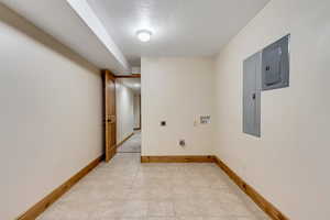 Washroom featuring washer hookup, electric dryer hookup, a textured ceiling, and electric panel