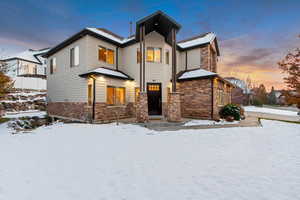 View of snow covered back of property