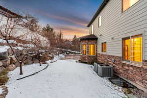 Snowy yard with central AC