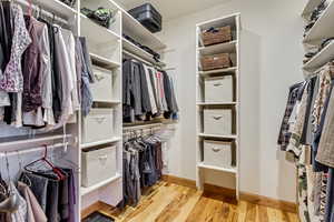 Walk in closet featuring hardwood / wood-style floors