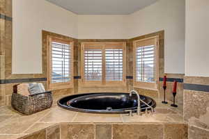 Bathroom featuring tiled bath