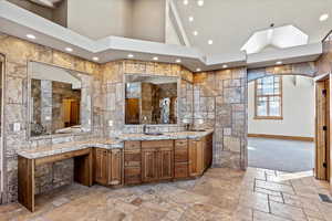 Bathroom with vanity and a towering ceiling