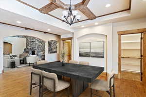 Dining room featuring a notable chandelier, beam ceiling, and light wood-type flooring