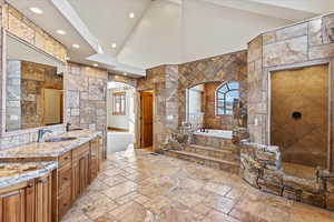 Bathroom featuring vanity and separate shower and tub