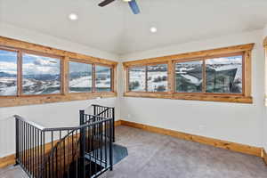 Interior space with a mountain view and ceiling fan