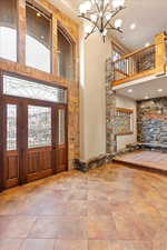 Entrance foyer featuring a high ceiling and a notable chandelier