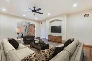 Living room featuring hardwood / wood-style flooring and ceiling fan