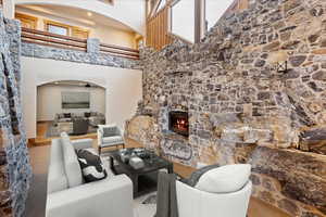 Living room with a fireplace and a high ceiling