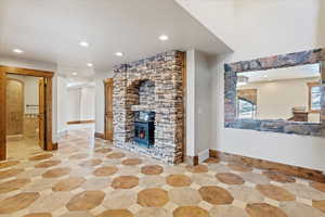 Unfurnished living room featuring a wood stove