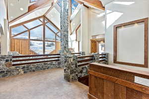 Bathroom with beam ceiling and high vaulted ceiling