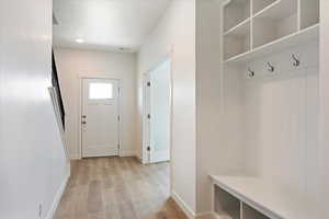 Mudroom with light hardwood / wood-style floors