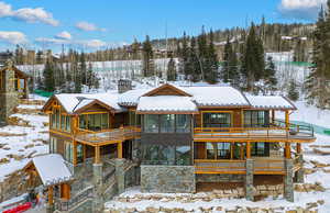 Snow covered property featuring a balcony