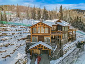 View of snow covered rear of property