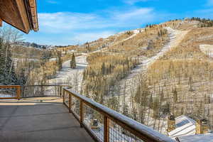 Snow covered back of property featuring a mountain view