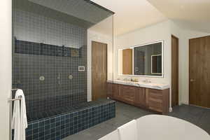 Bathroom with tile patterned flooring, vanity, and tiled shower