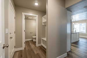 Bathroom featuring sink, a textured ceiling, and hardwood / wood-style flooring