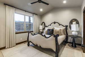 Bedroom with ceiling fan, light hardwood / wood-style floors, and lofted ceiling