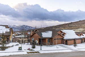 View of front of house featuring a mountain view and a garage