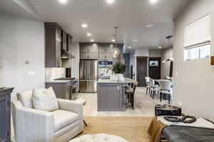 Living room with sink and light hardwood / wood-style flooring