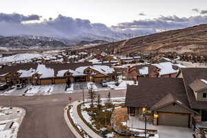 Snowy aerial view featuring a mountain view