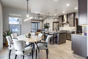 Dining room featuring plenty of natural light, ceiling fan, sink, and light hardwood / wood-style flooring