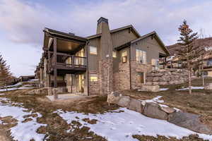 Snow covered house featuring a balcony