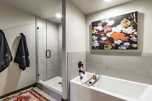 Bathroom with tile patterned floors and independent shower and bath