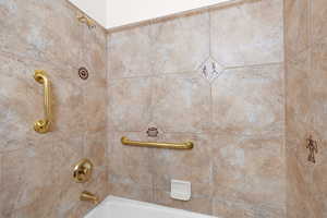 Hall bath featuring tiled shower / bath