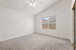 Master bedroom with ceiling fan and lofted ceiling