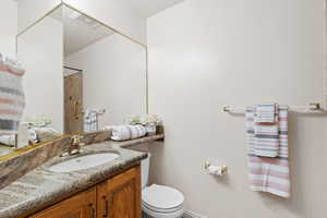 Hall bathroom featuring vanity and toilet and tub/shower