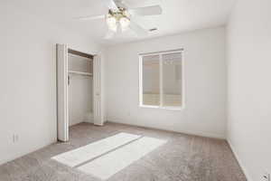 2nd bedroom featuring ceiling fan, light colored carpet, and a closet