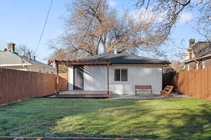 Back of house featuring a yard