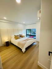 Bedroom with wood-type flooring