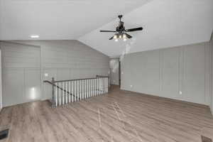 Bonus room with ceiling fan, light hardwood / wood-style floors, and vaulted ceiling