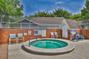 View of pool with a hot tub