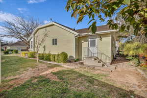 Back of property featuring a lawn