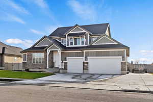 Exterior of home with large 4 car garage and paved RV pad