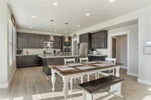 Kitchen with pendant lighting and stainless steel appliances.