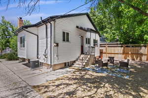 Back of house featuring an outdoor hangout area, a patio, and central air condition unit