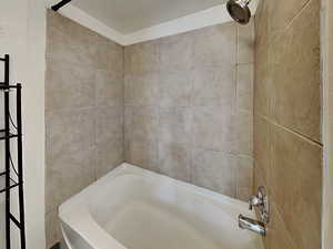 Bathroom featuring tiled shower / bath