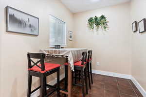 Dining room with dark tile patterned flooring