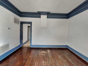 Unfurnished room featuring wood-type flooring and ornamental molding