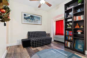 Living area with dark hardwood / wood-style floors